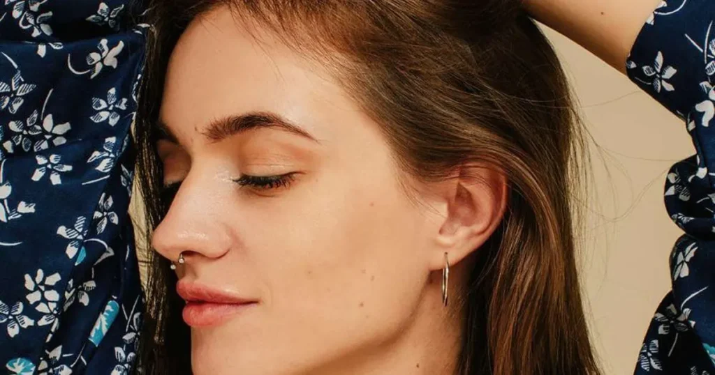 A woman with her nose and ear pierced-Healing Time By Piercing Type